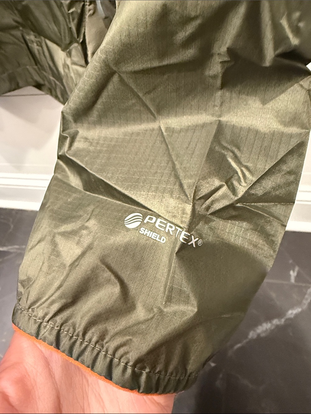 Outdoor Research Helium II jacket in green with orange zipper details. - Picture 4 of 7